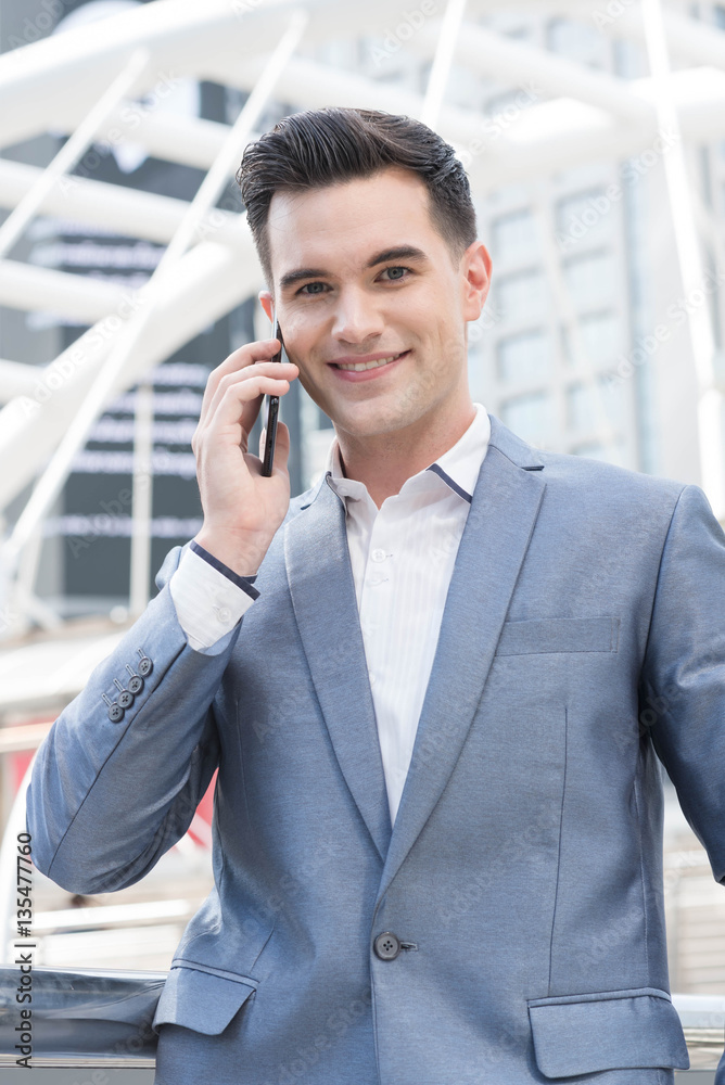Westerner Business man talking via smart phone on the public are Westerner Business man talking via smart phone on the public are