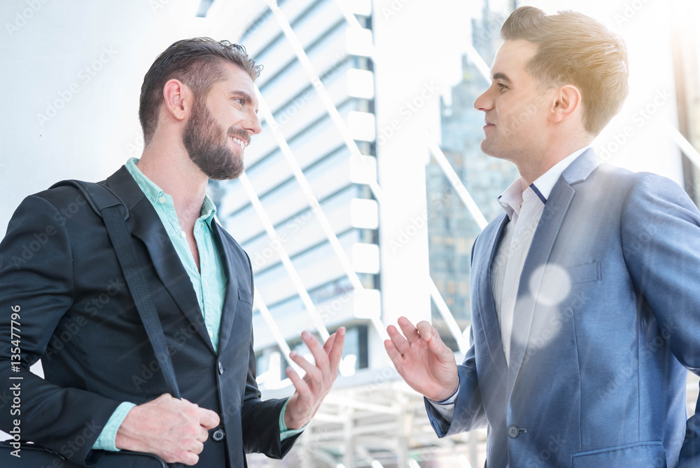 Fototapeta premium Two Westerner Business men talk and have good gesture on the pub