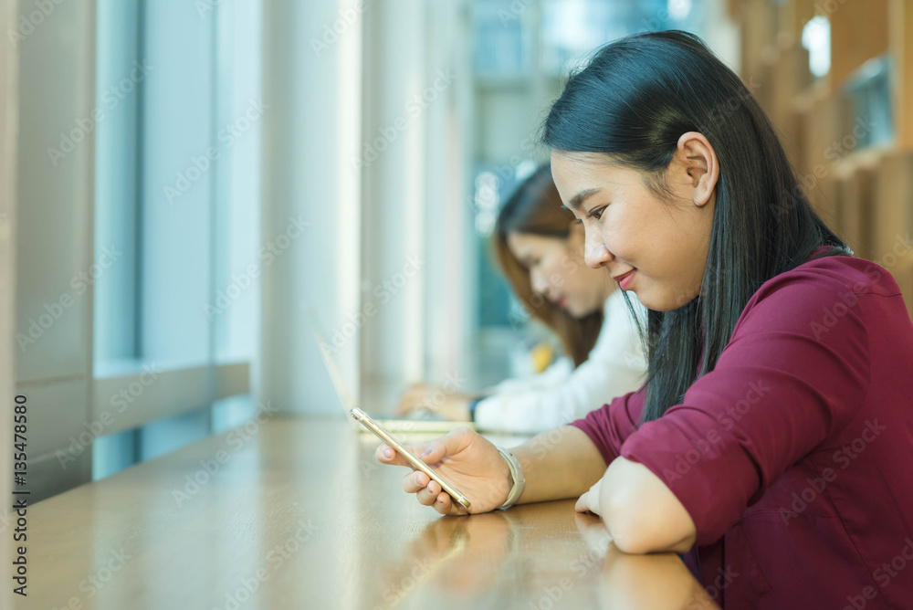 Girl use smartphone sit by the window Girl use smartphone sit by the window