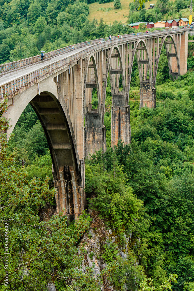 View of the old concrete arch Bridge Djurdjevica Tara in Montenegro. View of the old concrete arch Bridge Djurdjevica Tara in Montenegro.