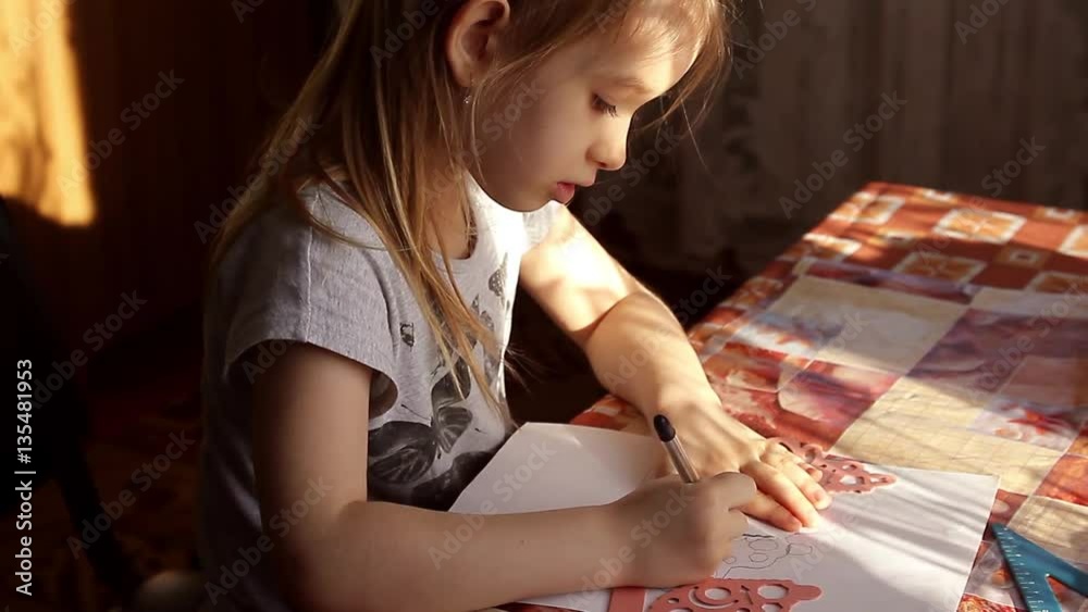 child performs the task in a notebook child performs the task in a notebook