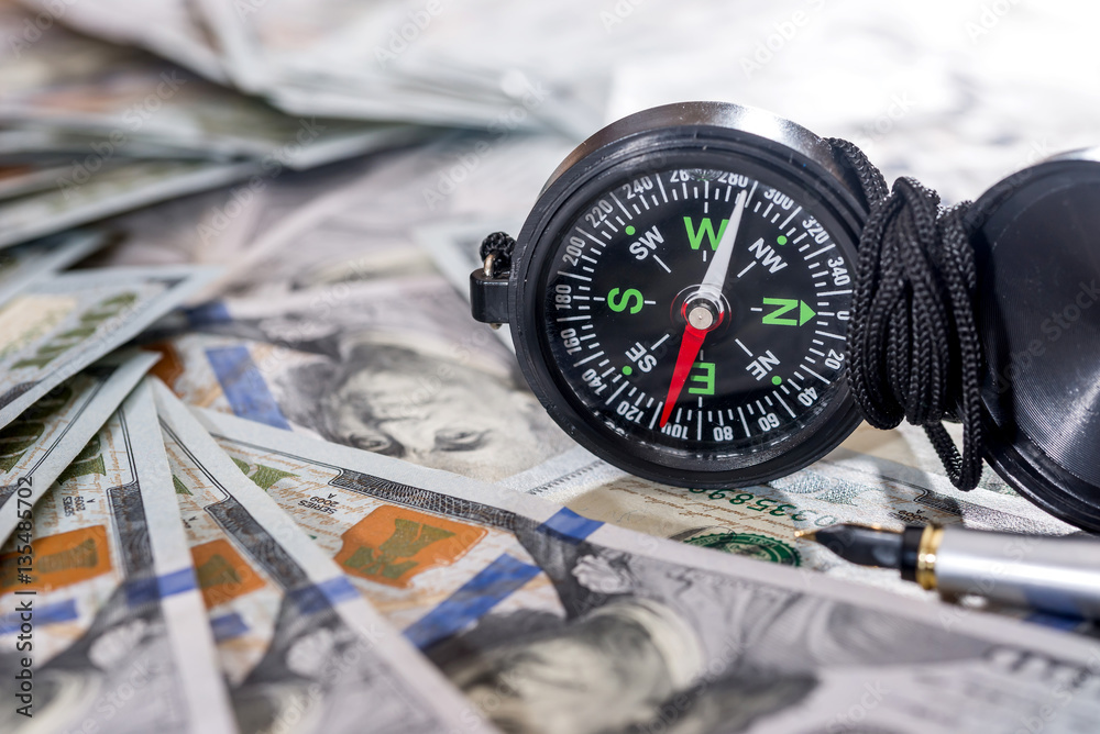 American dollar banknotes with compass. close up. American dollar banknotes with compass. close up.