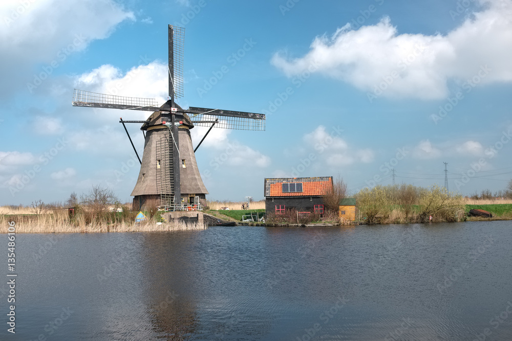 Windmill and old house in the Unesco site of Kinderdijk Windmill and old house in the Unesco site of Kinderdijk