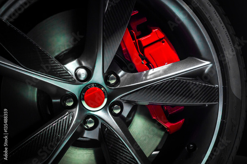Closeup of a beautiful large Alloy wheel of luxury car with painted brake callipers