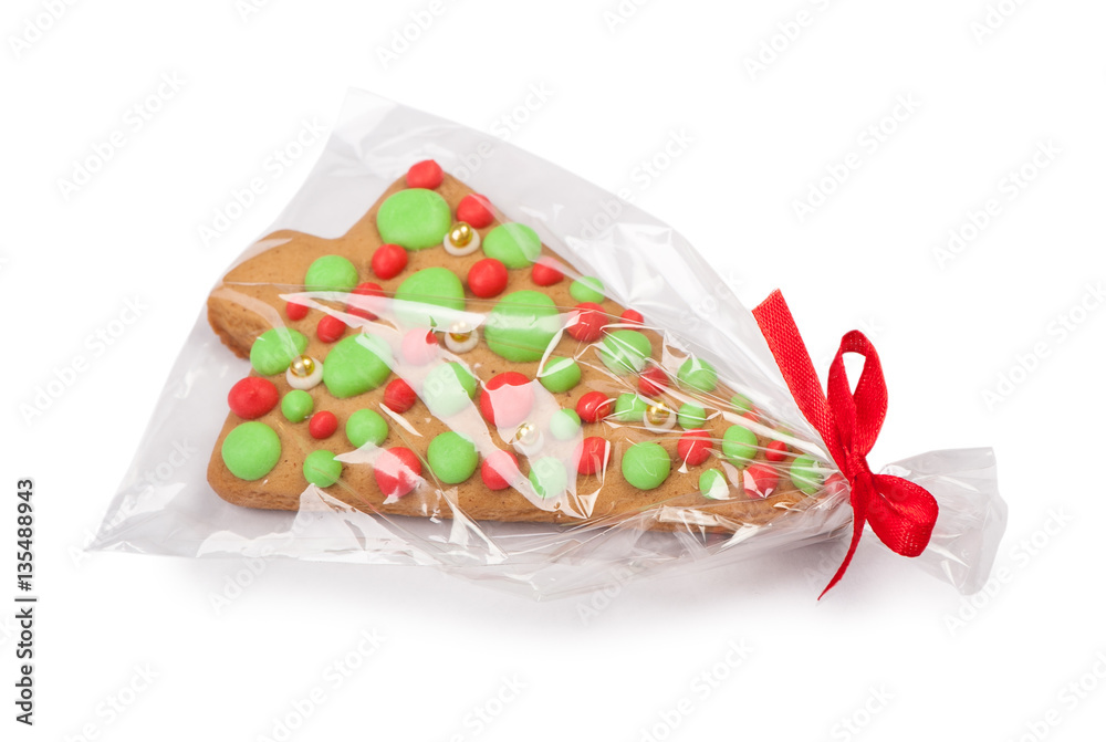Christmas gingerbread tree cookie in transparent packing with a Christmas gingerbread tree cookie in transparent packing with a