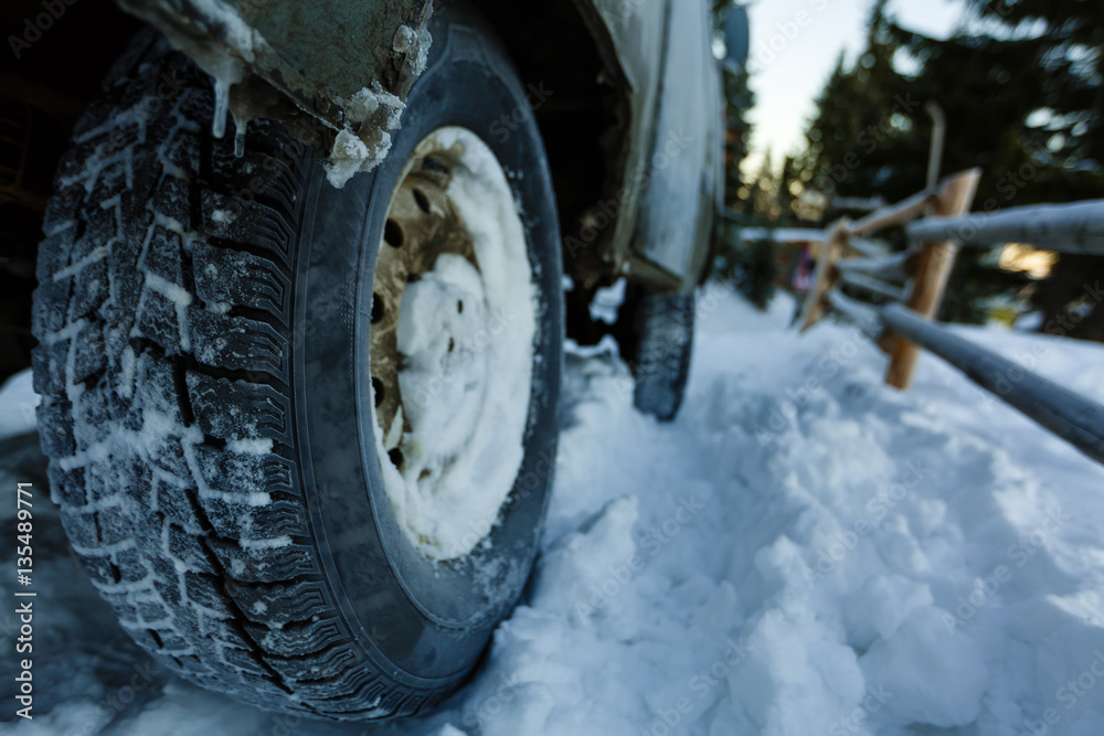 Cropped photo of car covered with snow. Winter tires on . Cropped photo of car covered with snow. Winter tires on .