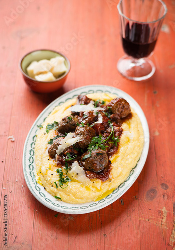 Homemade meatballs in tomato sauce with polenta