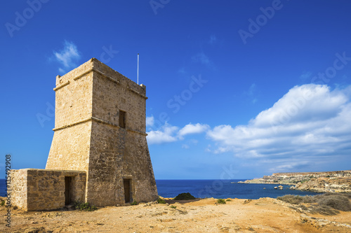Malta - Ghajn Tuffieha watchtower at Golden Bay on a nice sunny summer day with clear blue sky