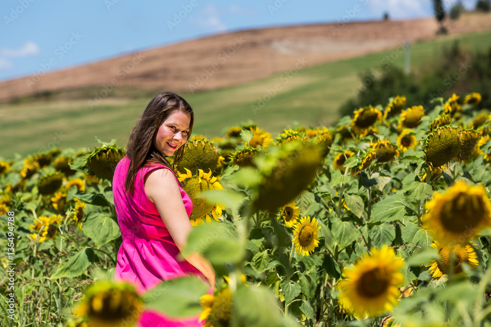 Girl standing in the Tuscan fields in summer Girl standing in the Tuscan fields in summer