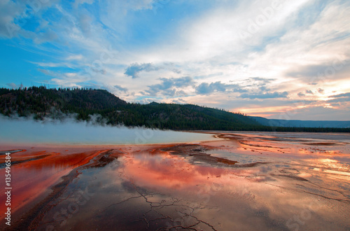 Grand Prismatic Spring under sunset cloudscape in the Midway Geyser Basin in Yellowstone National Park in Wyoming USA