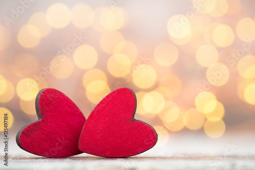 Red hearts on the wooden background.