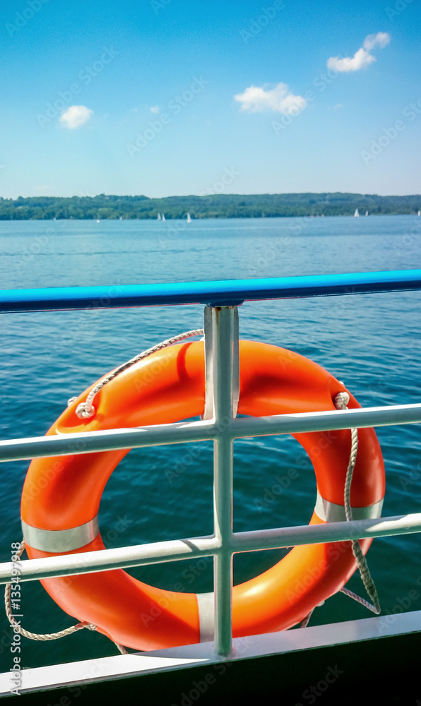 Fototapeta premium Lifebuoy on board ship at blue sky