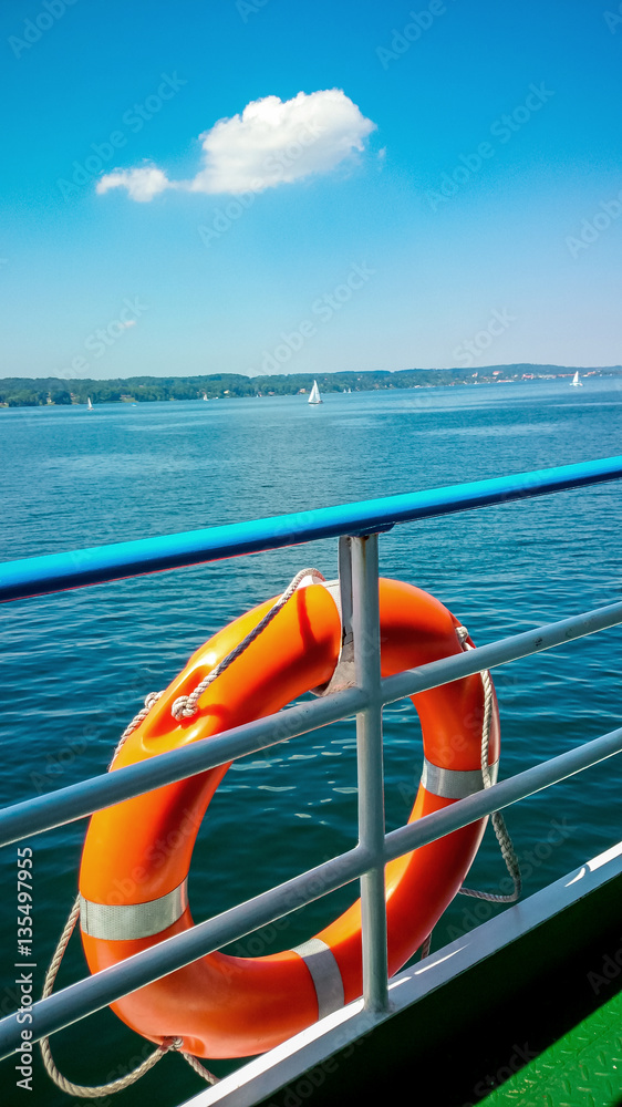 Fototapeta premium Lifebuoy on board ship at blue sky