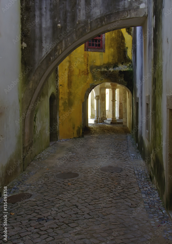 Old street with arches and a stone blocks in Sintra, Portugal.
