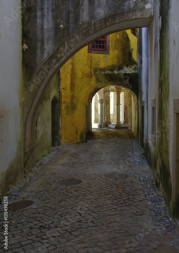 Old street with arches and a stone blocks in Sintra, Portugal. © vladk213