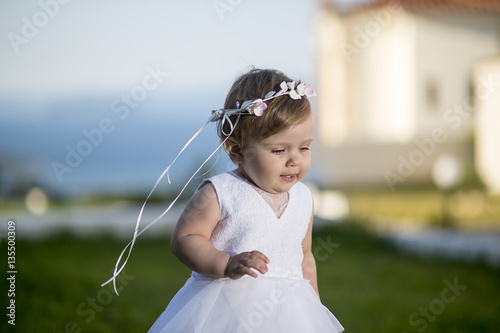 Sweet baby girl playing outdoors. Baptism, Wedding & Fashion