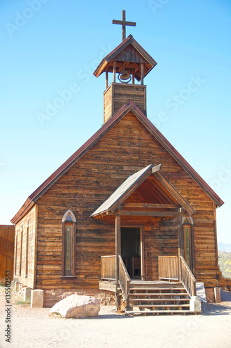 Old wooden american church with steeple and cross
