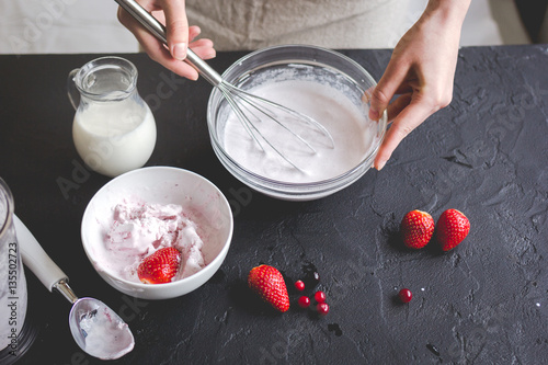 organic ice cream homemade process on dark background with hands