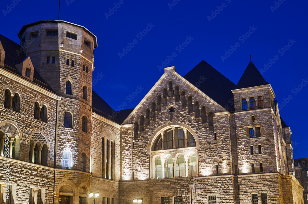 Imperial castle with tower at night in Poznan.