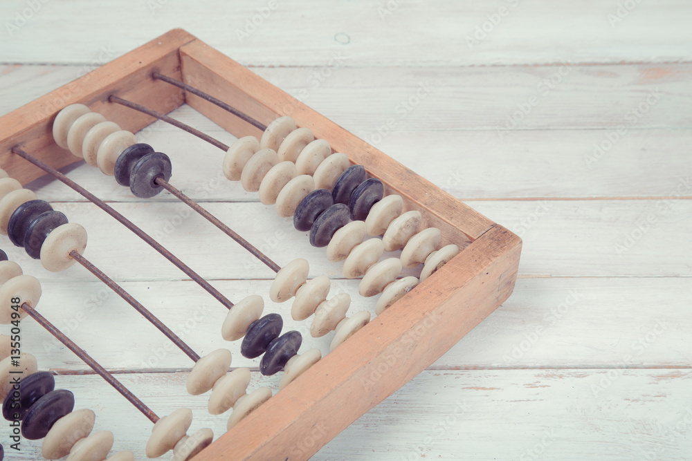 Naklejka premium Old vintage abacus on wooden background