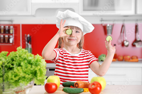 Small girl playing with veg...