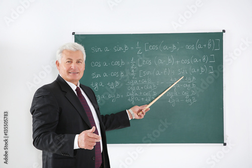 Senior teacher with pointer...