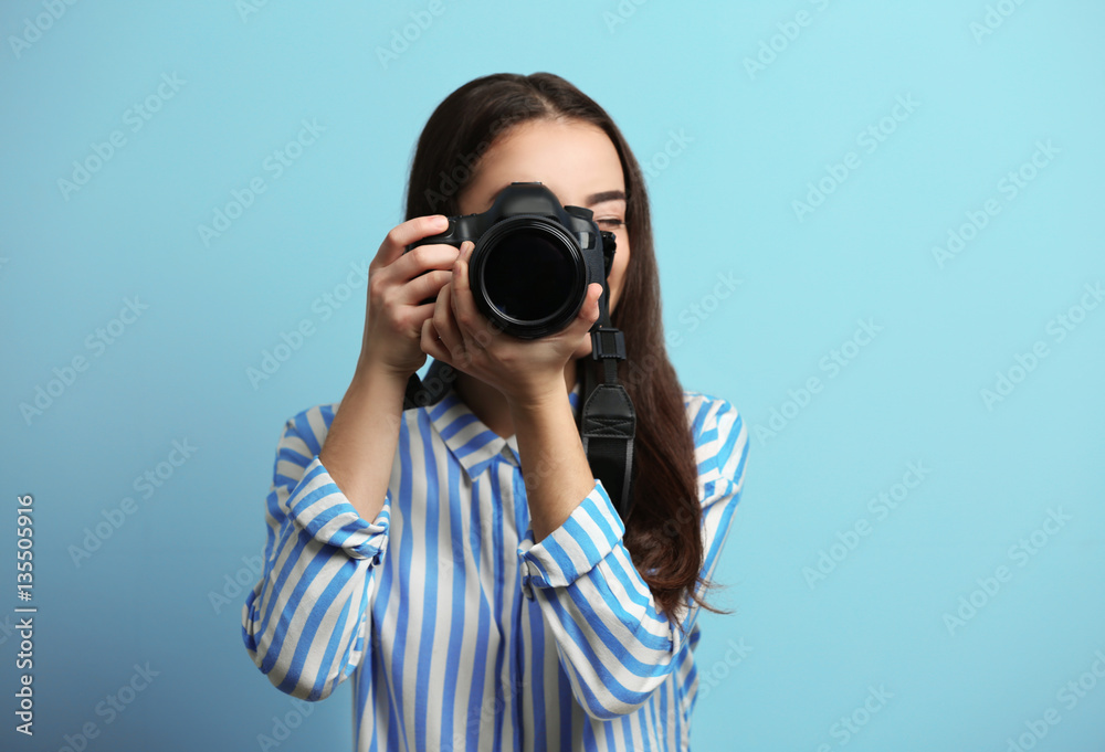 Beautiful young photographer on color background Beautiful young photographer on color background