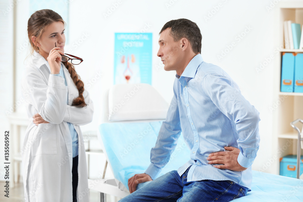 Fototapeta premium Young man visiting doctor at hospital