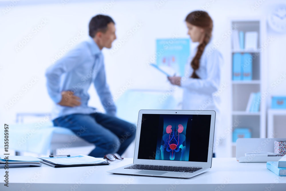 Medical concept. Laptop with urology image on doctor's desk Medical concept. Laptop with urology image on doctor's desk