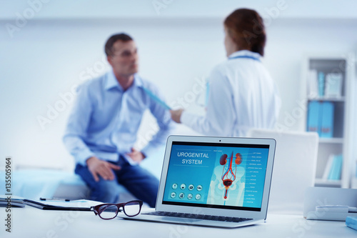 Medical concept. Laptop with urology image on doctor's desk photo
