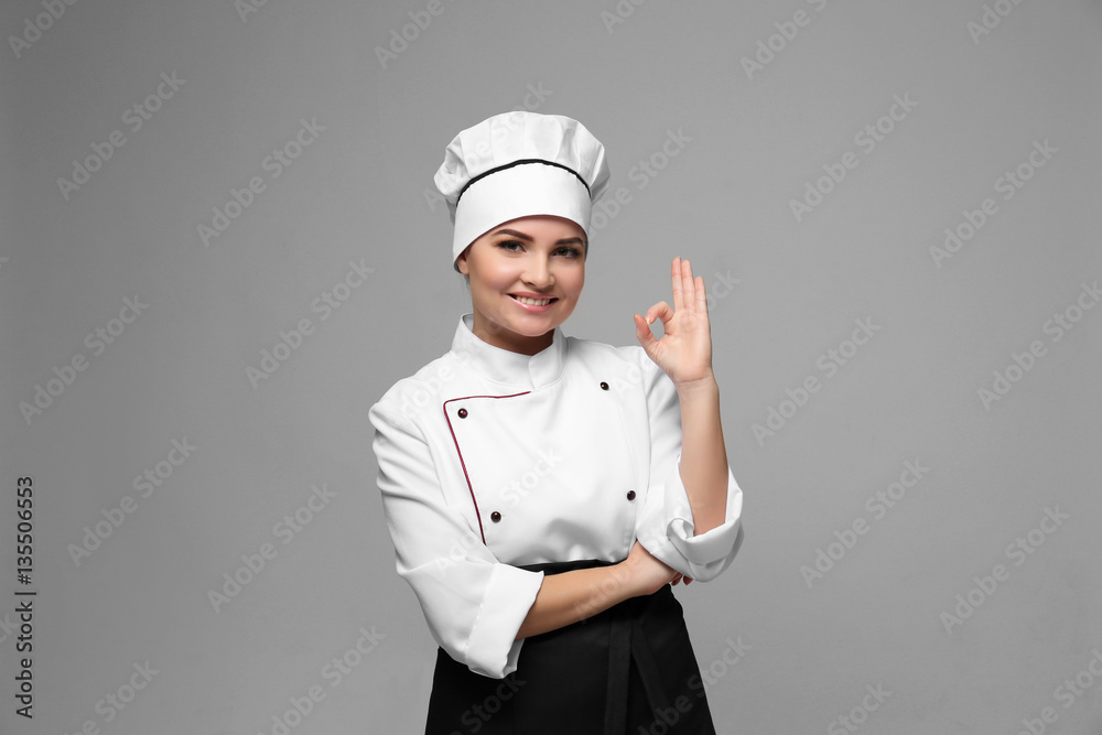 Portrait of young woman chef on light background Portrait of young woman chef on light background