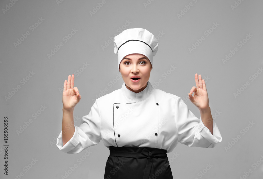 Portrait of young woman chef on light background Portrait of young woman chef on light background