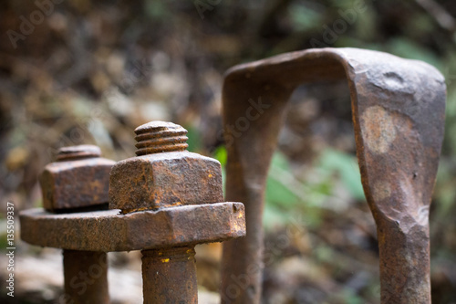 Rusted hardware from an abandoned old wooden wagon in a forest