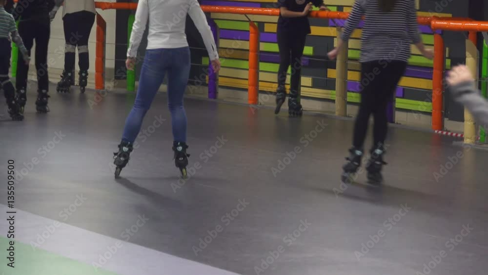 Crowd of teenagers and children ride on rollers at rollerdrome Crowd of teenagers and children ride on rollers at rollerdrome