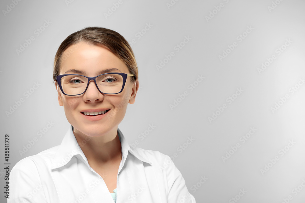 Young woman with spectacles on grey background Young woman with spectacles on grey background