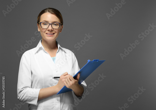 Young doctor with clipboard...