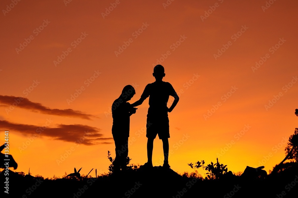 Silhouette of children playing in the forest