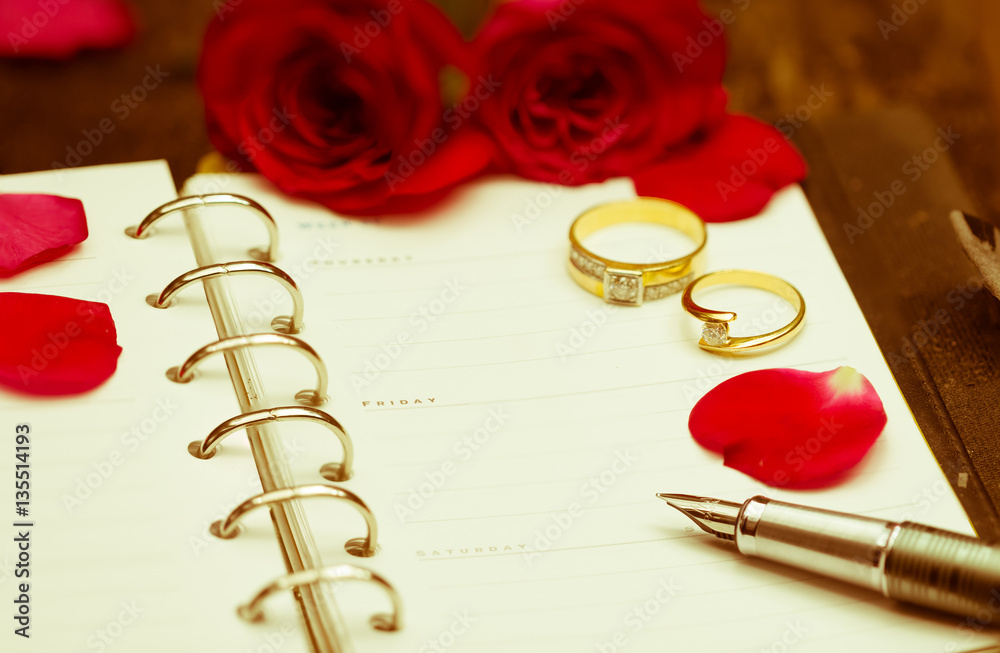 Diary note with red rose and couple ring,wedding ring Diary note with red rose and couple ring,wedding ring