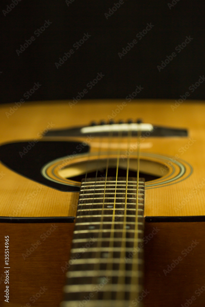 Fototapeta premium Acoustic guitar on black background