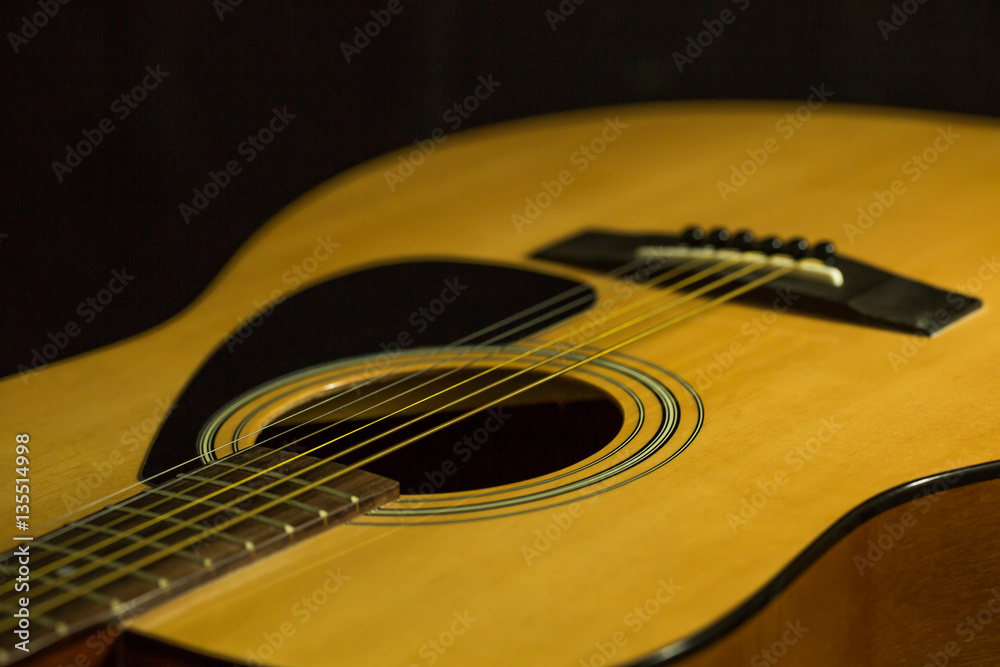Fototapeta premium Acoustic guitar on black background