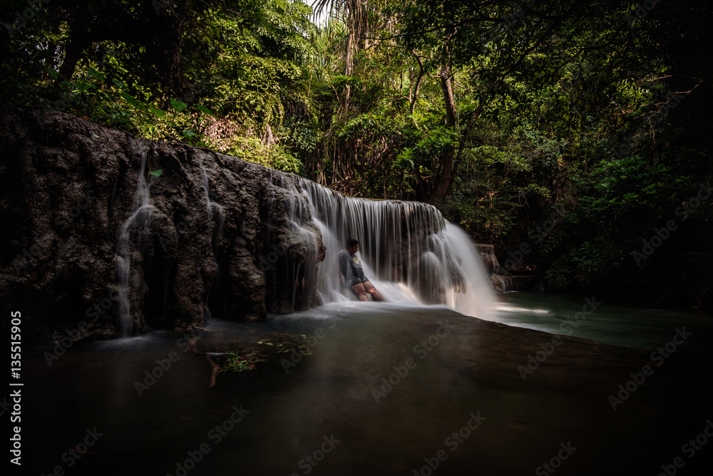 Fototapeta premium The woman in Huay Mae Kamin Waterfall in Kanchanaburi province, Thailand