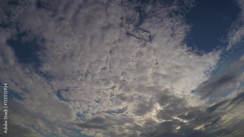 Clouds timelapse, fast motion of it at blue sky in summer day. photo