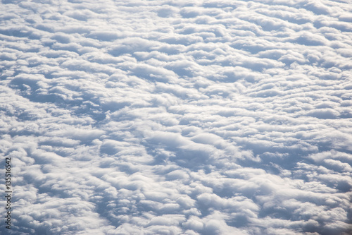 Banks of pristine, undulating clouds as seen from above