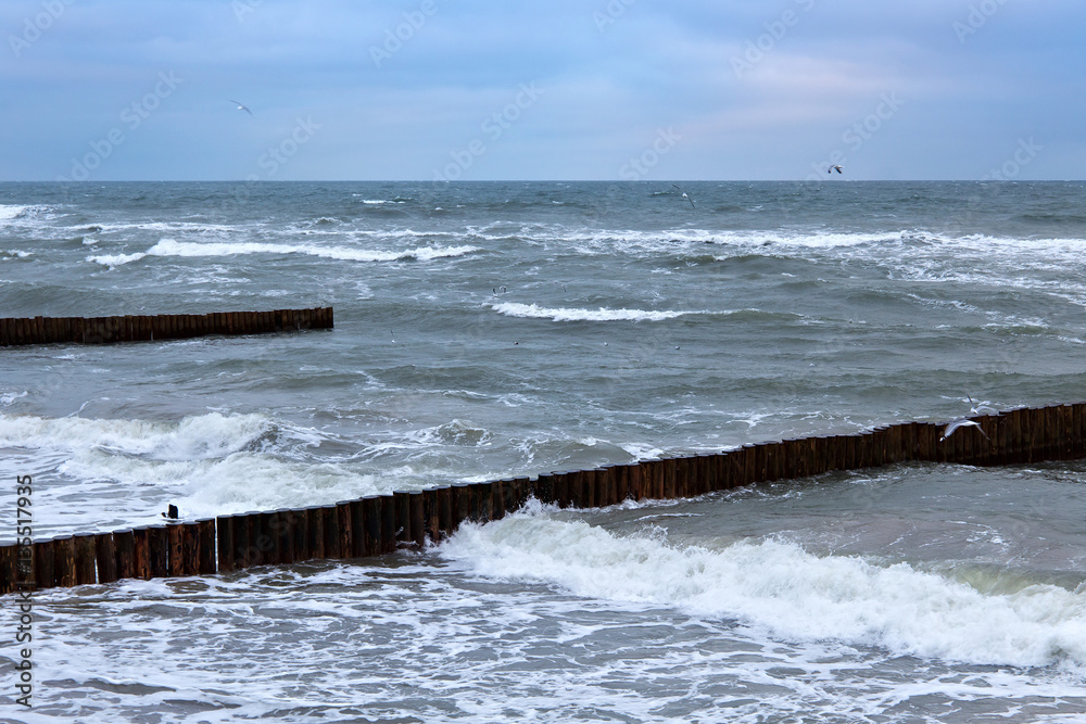 View of the Baltic Sea in the winter during a strong wind in overcast weather.