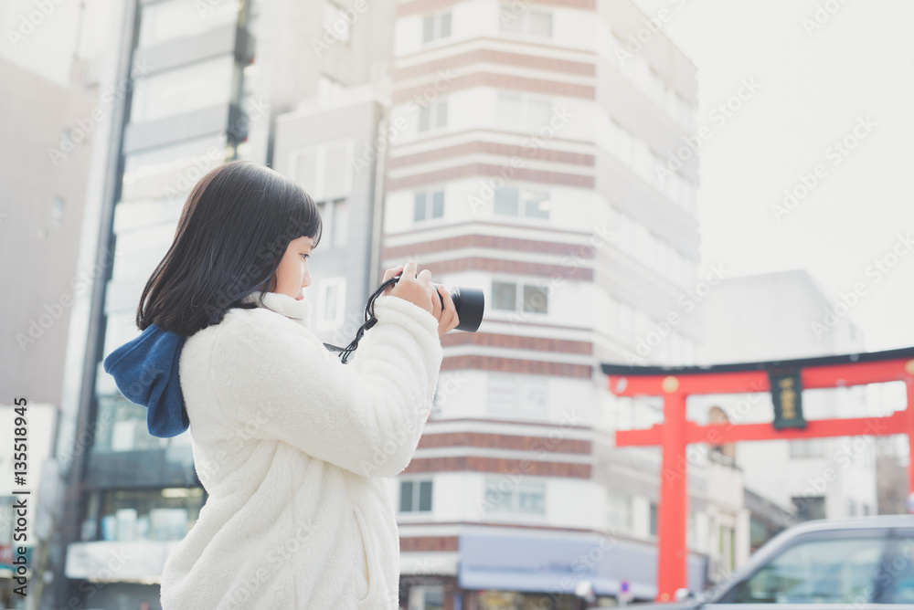 Asian girl with camera taking pictures