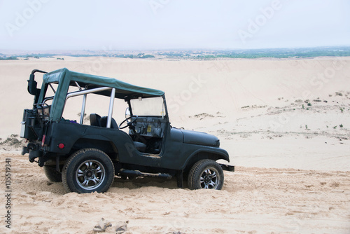 Jeep car with white sands. Vietnam desert,Popular tourist attrac