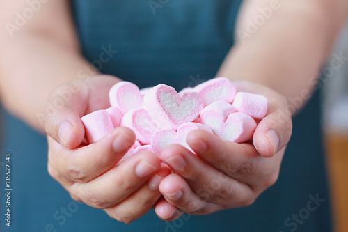 woman hand hold heart shape marshmallow for valentines day
