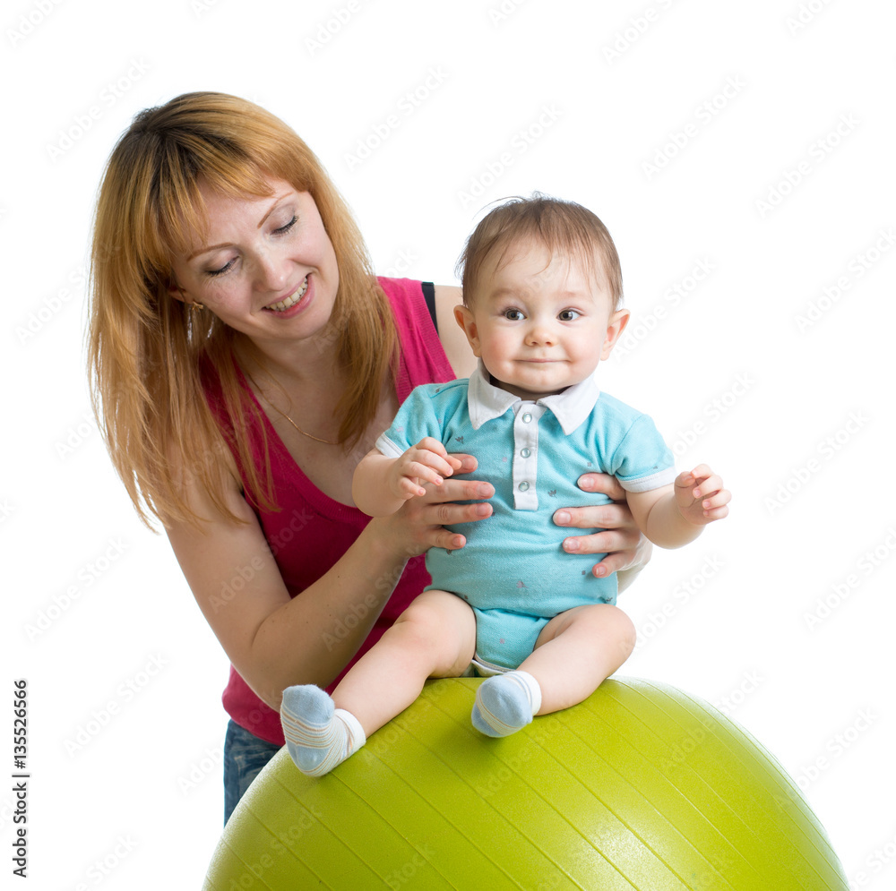 Mother with happy baby doing exercises with gymnastic ball. Concept of caring for children health. Mother with happy baby doing exercises with gymnastic ball. Concept of caring for children health.