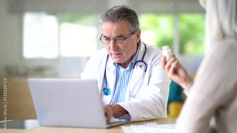 Patient at doctor's office receiving prescription Patient at doctor's office receiving prescription