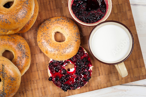 Obraz na płótnie Fresh homemade Poppy bagels bread with cup of milk, cream cheese w salonie